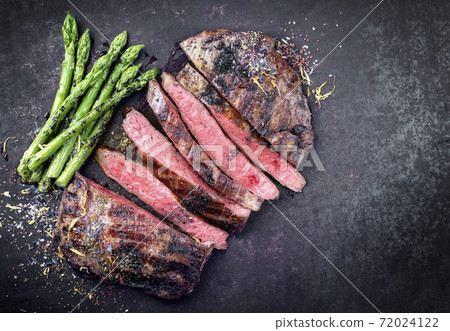 Barbecue dry aged wagyu flank steak sliced with green asparagus 72024122