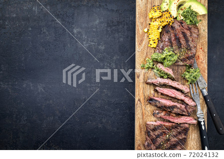 Barbecue dry aged wagyu flank steak with corn, avocado and chimichurri sauce Barbecue dry aged wagyu flank steak with corn, avocado and chimichurri sauce 72024132