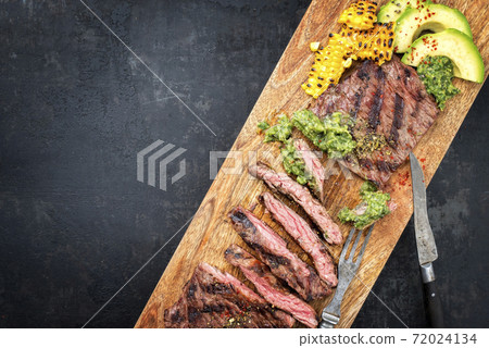 Barbecue dry aged wagyu flank steak with corn, avocado and chimichurri sauce Barbecue dry aged wagyu flank steak with corn, avocado and chimichurri sauce 72024134
