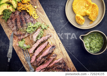 Barbecue dry aged wagyu flank steak with corn, avocado and chimichurri sauce Barbecue dry aged wagyu flank steak with corn, avocado and chimichurri sauce 72024135