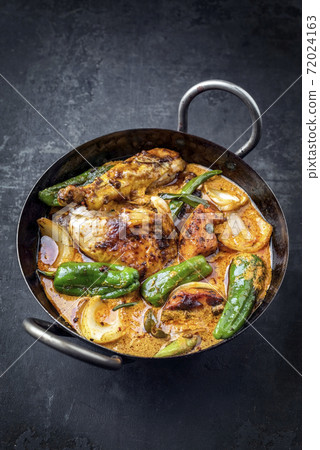 Traditional Thai kaeng massaman coconut chicken curry with jalapeno, poblano chili and sweet potato 72024163