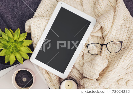 Tablet mock-up in lifestyle composition. Sweater, coffee, candle and glasses 72024223