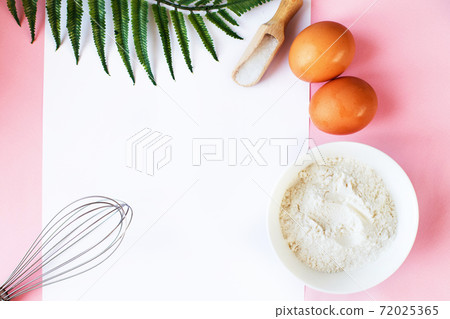 Ingredients for cooking baking - flour, egg, sugar, rolling pin on pink background. Concept of cooking dessert. 72025365