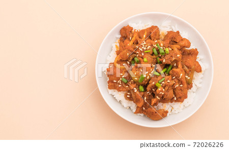 fried pork with spicy korean sauce (bulgogi) on top rice 72026226