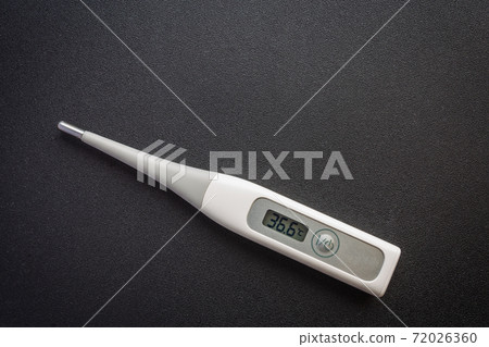 Picture of a thermometer on a dark background 72026360