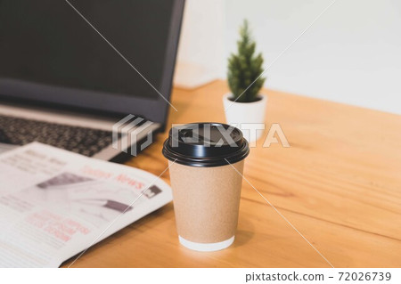 Selective focus on a cup of coffee on work desk Selective focus on a cup of coffee on work desk 72026739
