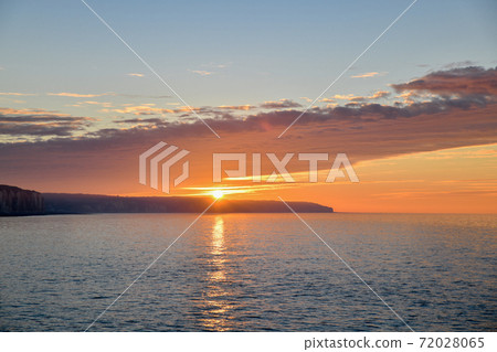 Sunset on the Atlantic ocean in Normandy and reflection on a water. 72028065