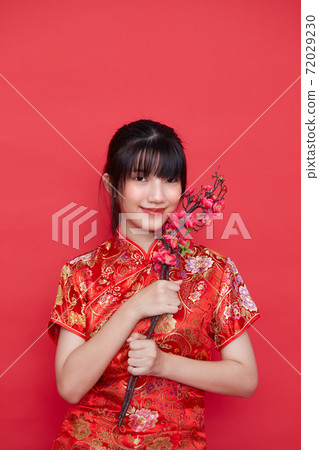 Asian women in red traditional Chinese dress Asian women in red traditional Chinese dress 72029230