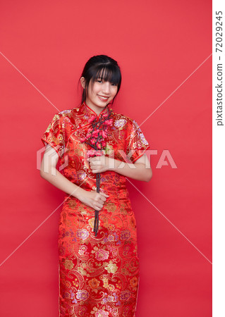 Asian women in red traditional Chinese dress Asian women in red traditional Chinese dress 72029245
