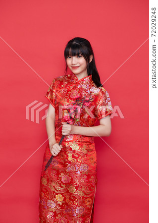 Asian women in red traditional Chinese dress Asian women in red traditional Chinese dress 72029248