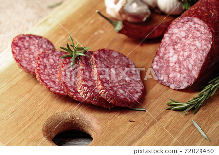 Salami on a cutting board. Salami on a cutting board. 72029430