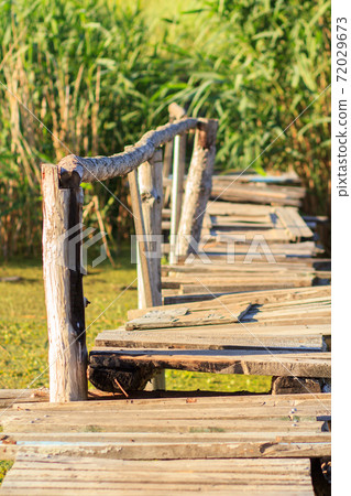 Old wooden bridge over the small river. 72029673