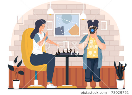 Photographer takes photos of a woman playing chess in cozy living room atmosphere in the evening 72029761