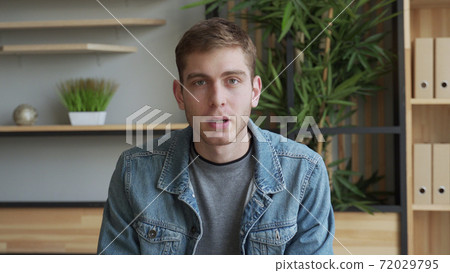 Businessman communication online looking at camera from home office. Entrepreneur conducting corporate video conference through webcam Businessman communication online looking at camera from home office. Entrepreneur conducting corporate video conference through webcam 72029795