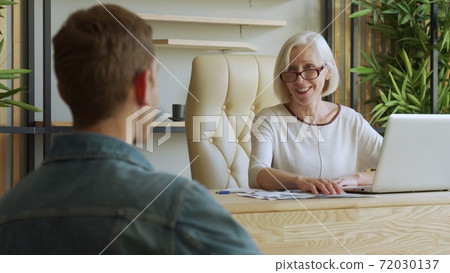 Elderly female boss communicate with subordinate. Recruiting new candidate at job interview 72030137
