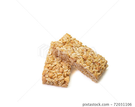 The close up of homemade Thai sweet cereal bar candy on white background, traditional muesli food in thailand. The close up of homemade Thai sweet cereal bar candy on white background, traditional muesli food in thailand. 72031106