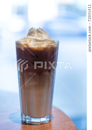 Iced coffee with whipped cream and sprinkle with almonds Iced coffee with whipped cream and sprinkle with almonds 72031411