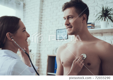 Woman checking the health of an athlete in office. 72033290