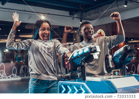 African couple smiling and enjoying victory. African couple smiling and enjoying victory. 72033333