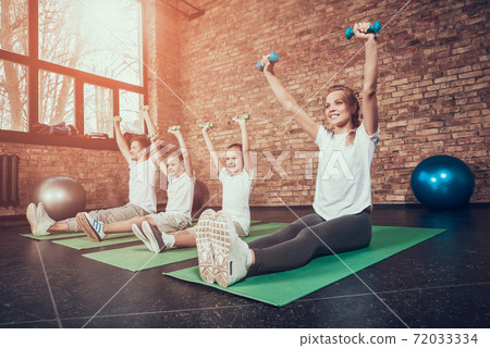Young family raised their hands up and sits . Young family raised their hands up and sits . 72033334