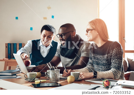 Multiracial team of editors are working in office. Multiracial team of editors are working in office. 72033352