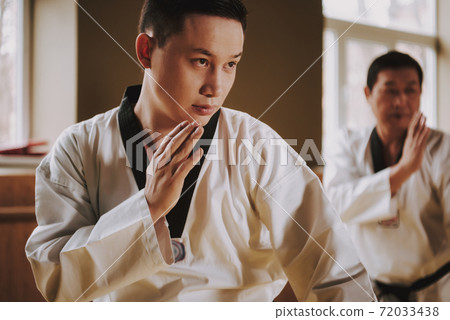 Two martial arts students in white keikogi. Two martial arts students in white keikogi. 72033438