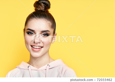 Headshot portrait of young happy woman smiling and looks at camera with copy space Headshot portrait of young happy woman smiling and looks at camera with copy space 72033462