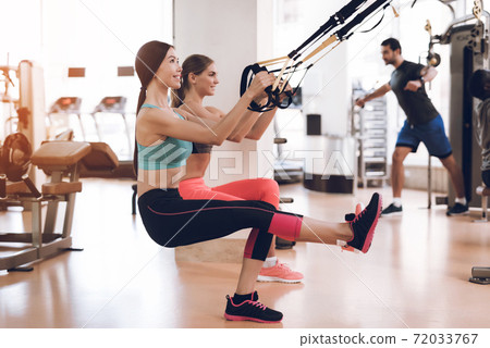 Athletes do exercises in a modern gym. Athletes do exercises in a modern gym. 72033767