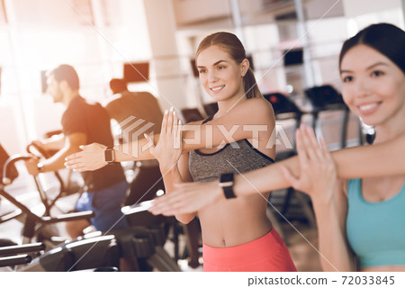 Two young girls knead in the modern gym. 72033845