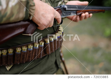Hunting Equipment Ammunition on Waist of Hunter. 72033865