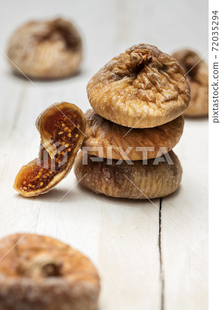 Dried figs on a white wooden background Dried figs on a white wooden background 72035294