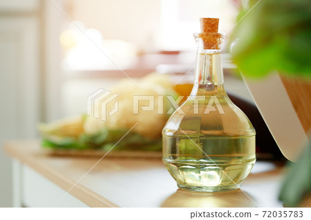 Glass bottle of oil on kitchen counter 72035783