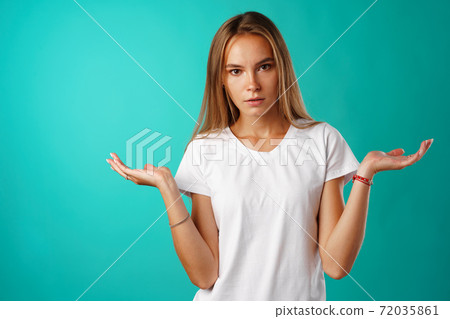 Amazed young woman gesturing that she doesn't know. Amazed young woman gesturing that she doesn't know. 72035861