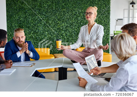 young caucasian woman meditating in office young caucasian woman meditating in office 72036067