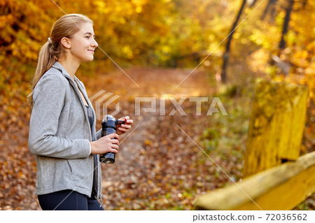 caucasian sporty woman with bottle of water outdoors caucasian sporty woman with bottle of water outdoors 72036562