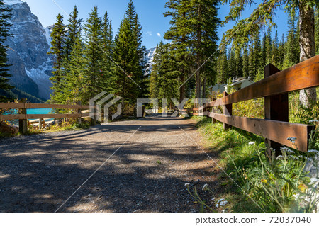 Moraine lake lakeshore trail in summer sunny day morning. Beautiful landscape in Banff National Park, Canadian Rockies. Alberta, Canada. 72037040