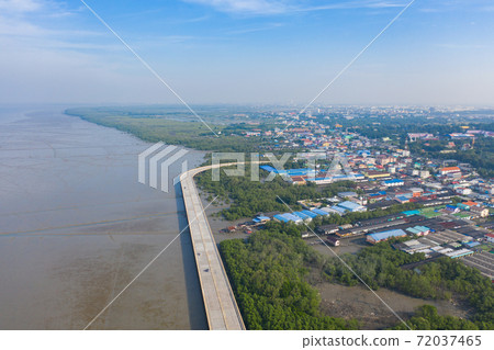 Aerial view of Chon Ra Mak Vi Tee Bridge Road in Sri Racha district with sea, Chonburi skyline, Thailand. Urban city in Asia. Architecture landscape background. Aerial view of Chon Ra Mak Vi Tee Bridge Road in Sri Racha district with sea, Chonburi skyline, Thailand. Urban city in Asia. Architecture landscape background. 72037465