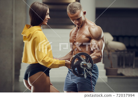 Sporty fitness couple working out in gym Sporty fitness couple working out in gym 72037994