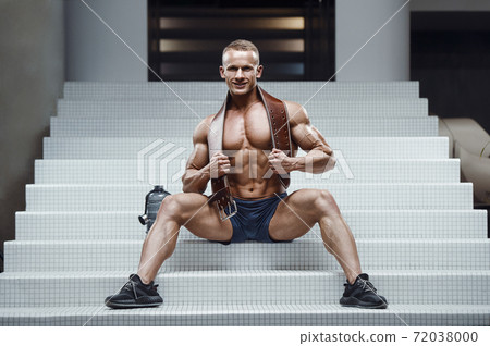 Bodybuilder drinking water after fitness workout Bodybuilder drinking water after fitness workout 72038000
