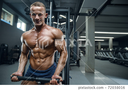 Caucasian man pumping up muscles. fitness training Caucasian man pumping up muscles. fitness training 72038016