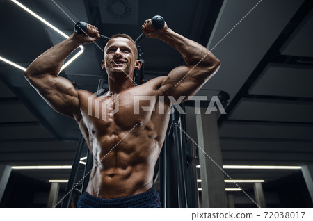 Caucasian man pumping up muscles. fitness training 72038017