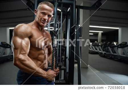 Caucasian man pumping up muscles. fitness training 72038018