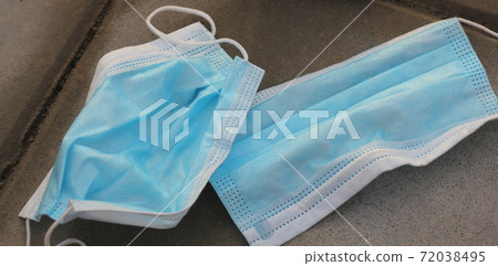 Used medical face mask thrown out on the street waste littered in the city discarded after one use. Dirty PPE not reusable. Used medical face mask thrown out on the street waste littered in the city discarded after one use. Dirty PPE not reusable. 72038495