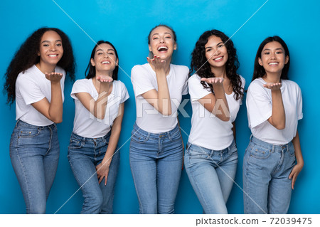 Five Cheerful Multicultural Ladies Sending Air Kisses Over Blue Background Five Cheerful Multicultural Ladies Sending Air Kisses Over Blue Background 72039475