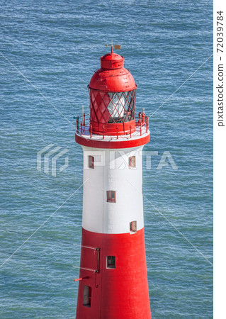 Beachy Head Lighthouse against blue sea near the Eastbourne, East Sussex, England Beachy Head Lighthouse against blue sea near the Eastbourne, East Sussex, England 72039784