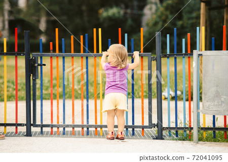 the blonde haired girl runs away from the playground 72041095