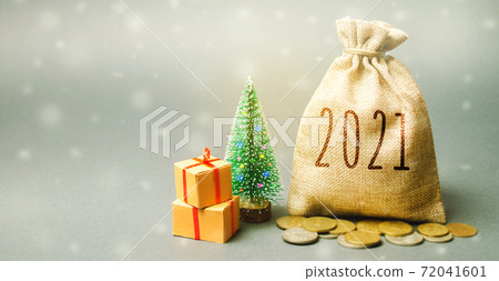 Money bag 2021, Christmas tree, and gifts. New Year or Xmas winter holiday. Accumulating money and planning a budget. Business and finance. Loans, deposit, credit. Promotions, offers 72041601