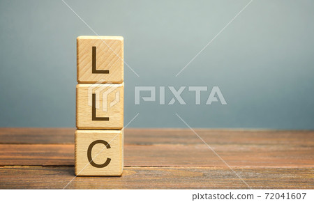 Wooden blocks with LLC - Limited Liability Company. Business concept. Hybrid companies that combine the characteristics of a corporation and a partnership. Business form permitted by state regulations 72041607