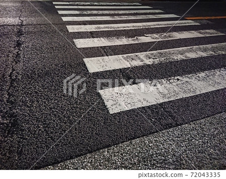 Pedestrian crossing on a rainy night Pedestrian crossing on a rainy night 72043335