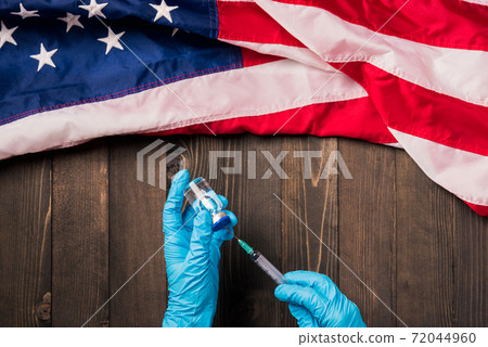 Hands of a doctor wearing gloves holding coronavirus 72044960